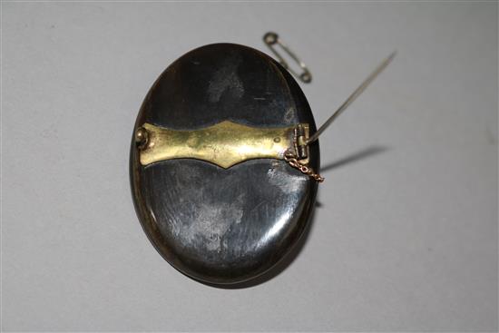 A horn mounted carved ivory cameo brooch, 2in.